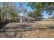 Spacious backyard with mature trees and a patio, perfect for outdoor activities at 303 Longleaf Rd, Summerville, SC 29486