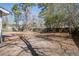 Open backyard featuring mature trees and a wooden deck at 303 Longleaf Rd, Summerville, SC 29486