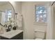 Bright bathroom with modern fixtures, a sleek vanity, and a window for natural light at 303 Longleaf Rd, Summerville, SC 29486