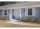 Inviting front porch with white columns, decorative lights, double doors, and manicured landscaping at 303 Longleaf Rd, Summerville, SC 29486