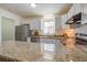 Well-lit kitchen with granite countertops and stainless steel appliances at 303 Longleaf Rd, Summerville, SC 29486
