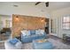Inviting living room with exposed brick, comfortable blue sofa, and a view into adjoining rooms at 303 Longleaf Rd, Summerville, SC 29486