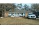 Brick ranch home with light blue siding, and a partially visible SUV in the front yard at 303 Longleaf Rd, Summerville, SC 29486