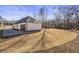 Spacious backyard with ample grassy area alongside the home's exterior at 7210 Raw Dew Dr, Awendaw, SC 29429