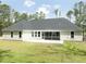 A well-maintained backyard with a patio and screened porch, perfect for outdoor relaxation and entertaining at 7210 Raw Dew Dr, Awendaw, SC 29429