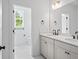 Bright bathroom offers double vanity with quartz countertops, and a view into the adjacent water closet at 7210 Raw Dew Dr, Awendaw, SC 29429