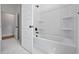 Clean bathroom boasts a bathtub-shower combo with tiled surround, with access to an adjacent hallway at 7210 Raw Dew Dr, Awendaw, SC 29429