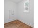Cozy bedroom has wood-look floors, a window and an access door to what might be attic space at 7210 Raw Dew Dr, Awendaw, SC 29429