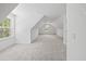 Spacious bonus room features carpeted floors and windows that let in ample natural light at 7210 Raw Dew Dr, Awendaw, SC 29429