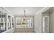 Bright dining room with a large window and a stylish chandelier at 7210 Raw Dew Dr, Awendaw, SC 29429