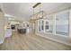 Open dining area with hardwood floors and a view into the kitchen and living room at 7210 Raw Dew Dr, Awendaw, SC 29429