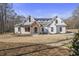 Stunning farmhouse exterior with white siding, wood accents, and a charming front porch at 7210 Raw Dew Dr, Awendaw, SC 29429