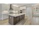 Modern kitchen featuring a large island, white cabinets, and stainless steel appliances at 7210 Raw Dew Dr, Awendaw, SC 29429