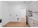 The laundry room features modern cabinets, quartz countertops, and a sleek black faucet at 7210 Raw Dew Dr, Awendaw, SC 29429