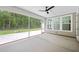 Screened-in porch featuring a concrete floor and view of the wooded backyard at 7210 Raw Dew Dr, Awendaw, SC 29429