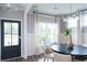 Bright dining room with a round table, neutral decor, and large windows at 778 Opal Wing St, Moncks Corner, SC 29461
