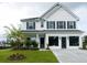 Two-story white house with gray shutters, landscaping, and a driveway at 778 Opal Wing St, Moncks Corner, SC 29461