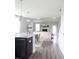 Open concept kitchen with island, dark cabinetry, and hardwood floors at 778 Opal Wing St, Moncks Corner, SC 29461