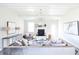 Spacious living room with fireplace, large windows, and comfy furniture at 778 Opal Wing St, Moncks Corner, SC 29461
