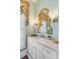 Powder room with a white vanity, marble countertop, and decorative wallpaper at 79 Alexander St, Charleston, SC 29403