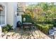 Outdoor patio with dining set and lush greenery at 79 Alexander St, Charleston, SC 29403
