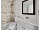 Updated bathroom with grey vanity, shower, and bathtub at 110 Manchester Rd, Summerville, SC 29486