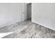 Simple bedroom with new flooring and an open door to another room at 110 Manchester Rd, Summerville, SC 29486