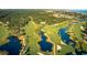 Aerial view of golf course with ponds and lush greenery at 1116 Summerwind Ln, Seabrook Island, SC 29455