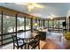Bright sunroom with golf course views, seating area, and dining table at 1116 Summerwind Ln, Seabrook Island, SC 29455