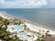 Stunning aerial view of oceanfront resort with pools, palm trees, beach access, and lounge areas at 1116 Summerwind Ln, Seabrook Island, SC 29455
