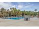 Inviting community pool area with lounge chairs, pergolas, play area, and palm trees for a relaxing atmosphere at 1116 Summerwind Ln, Seabrook Island, SC 29455