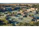 Aerial view of tennis courts surrounded by lush landscaping and residences in a vibrant community at 1116 Summerwind Ln, Seabrook Island, SC 29455