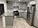 Updated kitchen with gray cabinets, granite countertops, and stainless steel appliances at 114 Groves St, Walterboro, SC 29488