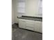 Kitchen features white cabinets and a granite countertop at 114 Groves St, Walterboro, SC 29488