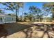 Large backyard with mature trees and a grassy area at 1216 Taliaferro Ave, Charleston, SC 29412