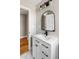 Clean bathroom with white vanity, hexagon tile, and arched mirror at 1216 Taliaferro Ave, Charleston, SC 29412