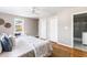 Bright bedroom with a queen bed, hardwood floors, and an ensuite bathroom at 1216 Taliaferro Ave, Charleston, SC 29412