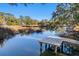 Wooden dock extending over calm water, ideal for relaxing at 1216 Taliaferro Ave, Charleston, SC 29412