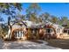 Newly renovated brick home with a large driveway and mature trees at 1216 Taliaferro Ave, Charleston, SC 29412