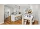 Modern kitchen with white cabinets, island, and hardwood floors at 1216 Taliaferro Ave, Charleston, SC 29412