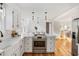 Updated kitchen with white cabinets, quartz countertops, and island at 1216 Taliaferro Ave, Charleston, SC 29412