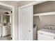 Bright laundry room with washer, dryer, and built-in shelving at 1216 Taliaferro Ave, Charleston, SC 29412