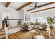 Spacious living room with exposed beams, a comfy sectional sofa, and a large window at 1216 Taliaferro Ave, Charleston, SC 29412
