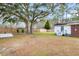 Large backyard with mature trees, wooden fence, and patio area at 127 Roberts Rd, Summerville, SC 29483