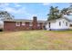 Expansive backyard featuring a brick house, green lawn, and access to both the main house and the adjacent white structure at 127 Roberts Rd, Summerville, SC 29483