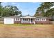 Brick ranch house with a white porch, attached garage, and well-maintained lawn at 127 Roberts Rd, Summerville, SC 29483