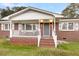 Brick house with a white front porch and gray front door at 127 Roberts Rd, Summerville, SC 29483