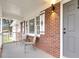 Inviting front porch with brick flooring and two metal chairs at 127 Roberts Rd, Summerville, SC 29483