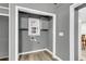 Small laundry room with gray walls, cabinets, and vinyl flooring at 127 Roberts Rd, Summerville, SC 29483