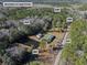 Aerial view of property showing home, detached garage, and pond at 151 Powerhouse Rd, Ridgeville, SC 29472